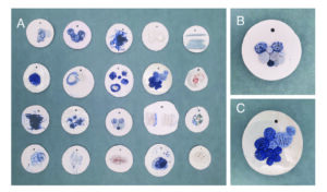 The first figure is a grid of 5 by 4 rows of small white clay tiles with various textures with variations of mostly blue hues. The second two figures are close up of two of the circle tiles. Each having a cluster of various sized small circular forms with a defined texture.