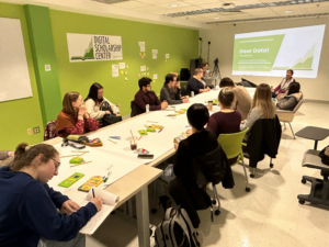 About a dozen campus participants watch a slide presentation in the Digital Scholarship Center entitled “Dear Data!” 