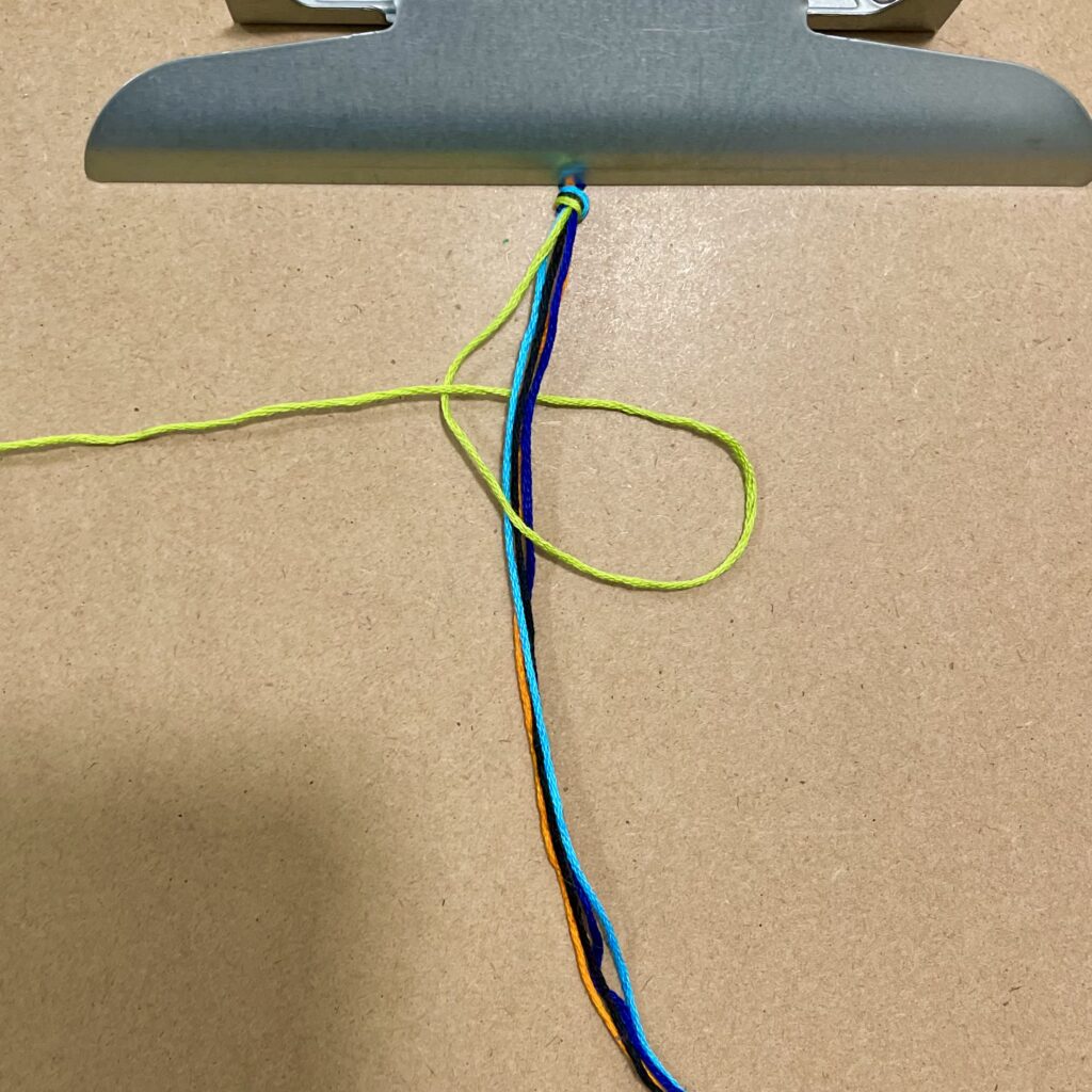 Figure 8. Step 10: Make a green left-hand knot.