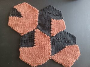 A collection of four completed woven pie charts, which are sewn together. Each one shows a different value: 77%, 25%, 85%, and 42%.