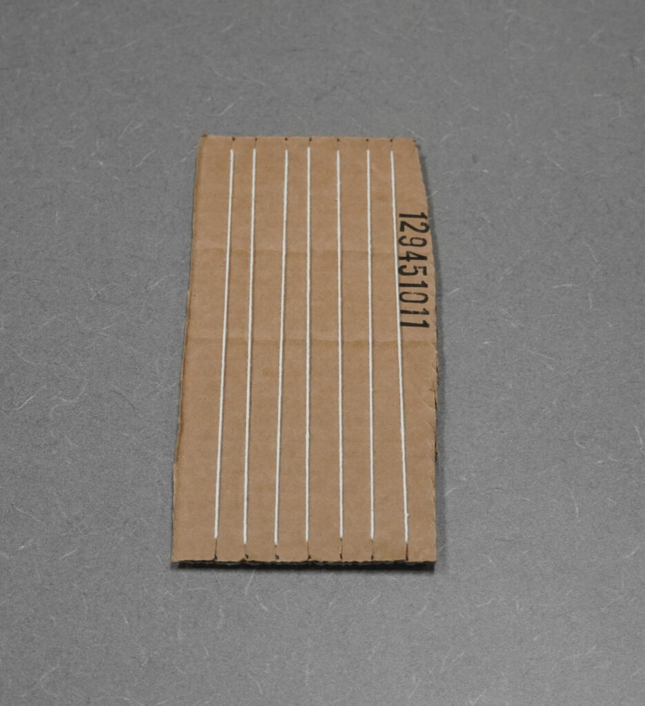 A completed cardboard loom from the front.