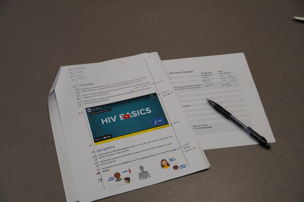 A printed copy of the C.D.C. website has been annotated and numbered by hand. Tucked underneath is a paper with a partially completed table provides space for a participant to track changes and their notes.